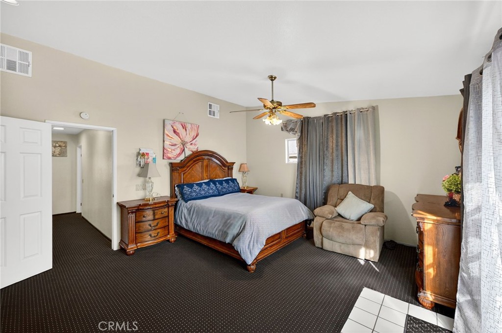 4153 North Webster Avenue Perris, CA 92571 - Photo 27 of 49 a bedroom with a bed couch and a window