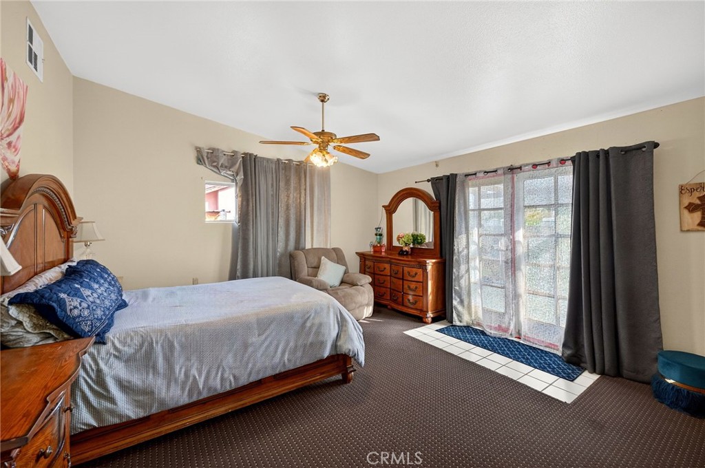 4153 North Webster Avenue Perris, CA 92571 - Photo 29 of 49 a bedroom with a bed and glass window