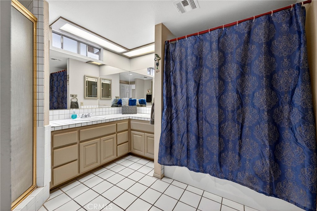 4153 North Webster Avenue Perris, CA 92571 - Photo 30 of 49 a spacious bathroom with a sink and a mirror