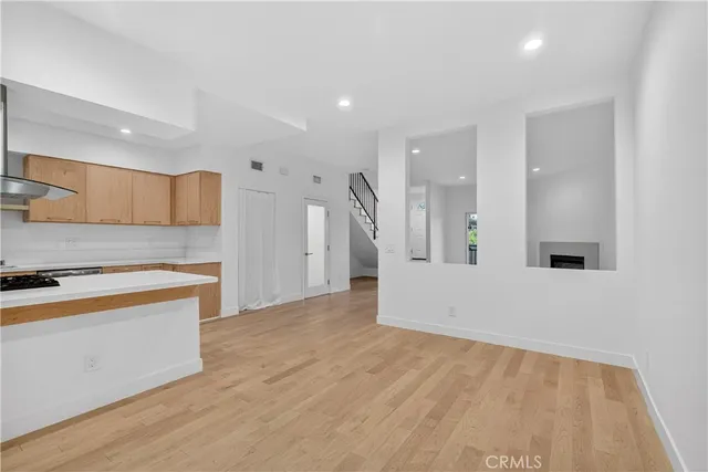 a large kitchen with stainless steel appliances granite countertop a stove and a refrigerator