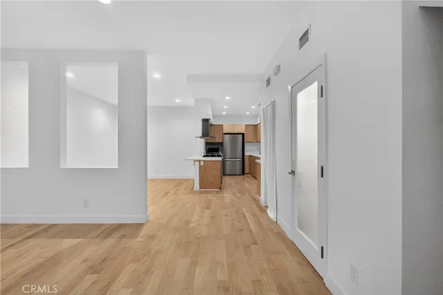 a view of a kitchen with a sink and refrigerator