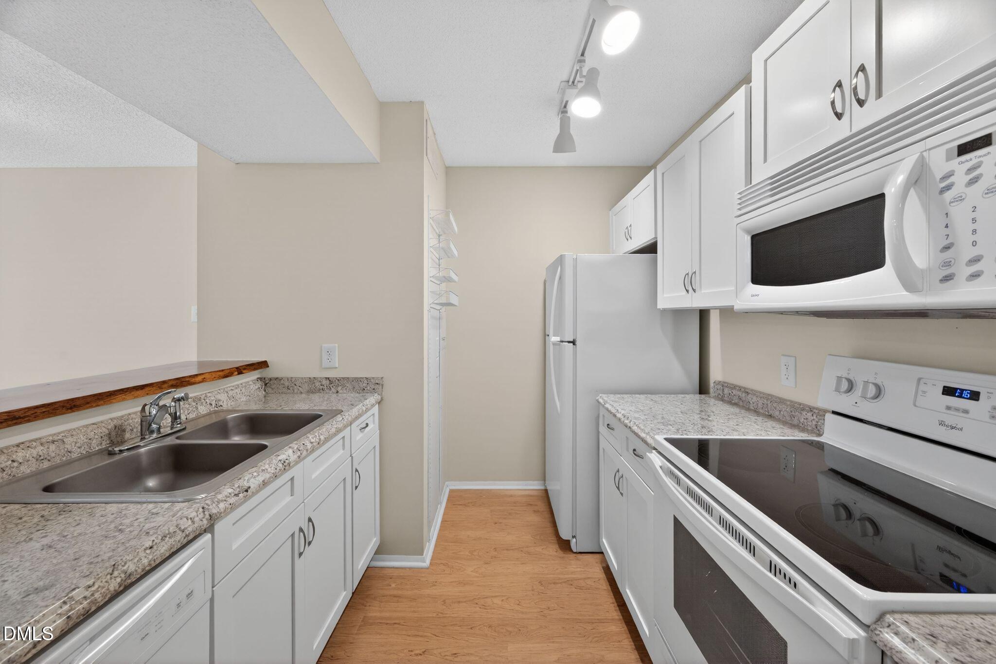 3704 Chimney Ridge Place, Unit 207 Durham, NC 27713 - Photo 5 of 31 a kitchen with stainless steel appliances granite countertop a sink and a stove