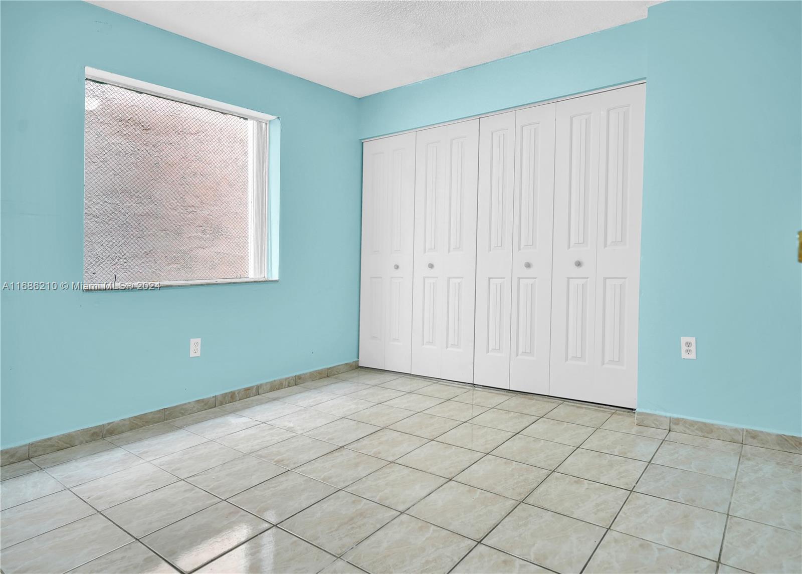 7462 West 29th Way Hialeah, FL 33018 - Photo 11 of 13 a view of an empty room with window