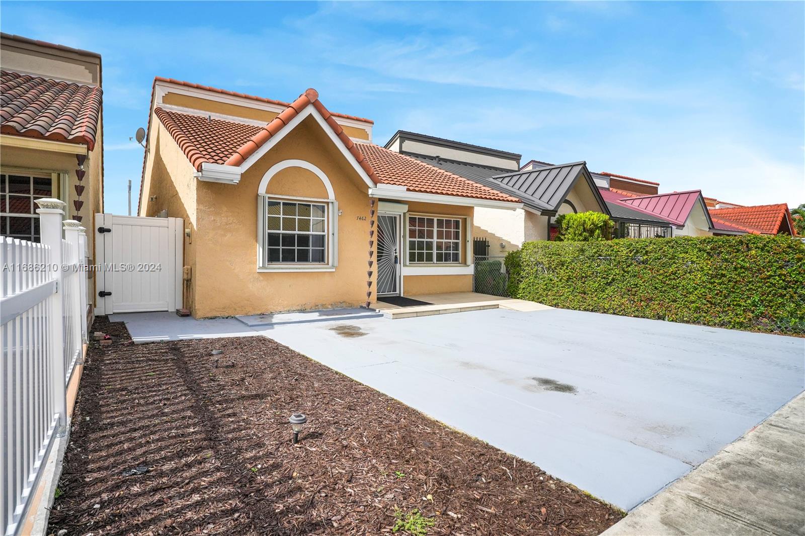 7462 West 29th Way Hialeah, FL 33018 - Photo 13 of 13 a front view of a house with a yard and garage