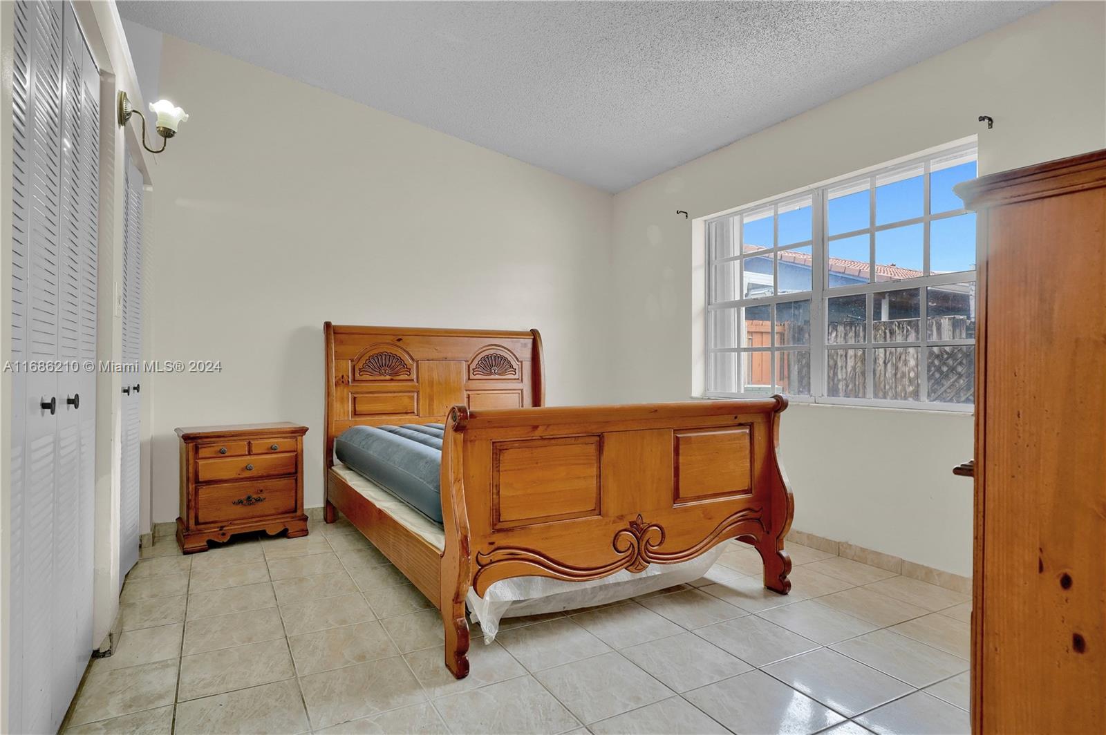 7462 West 29th Way Hialeah, FL 33018 - Photo 6 of 13 a bedroom with a bed and a window