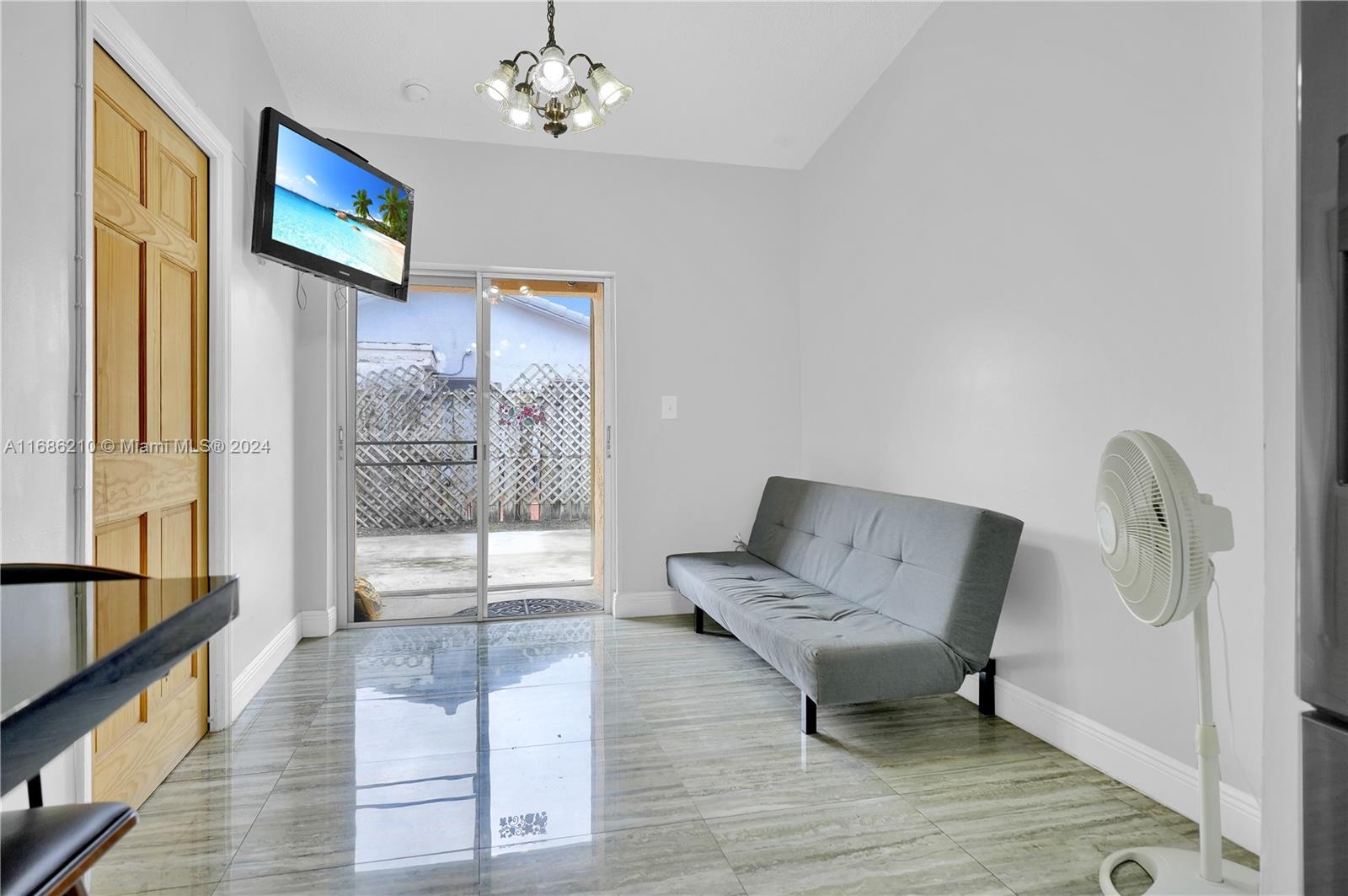 7462 West 29th Way Hialeah, FL 33018 - Photo 8 of 13 a living room with furniture and a flat screen tv
