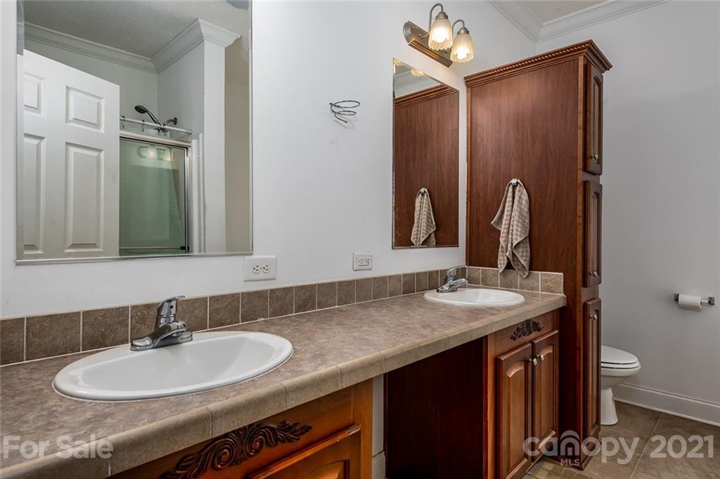 4478 Hickory Nut Ridge Road Hudson, NC 28638 - Photo 19 of 29 a bathroom with a granite countertop sink and a mirror