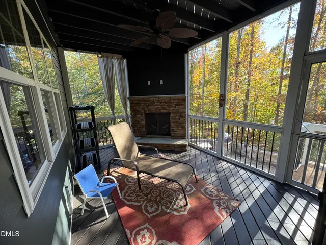a living room with furniture fireplace and a large window