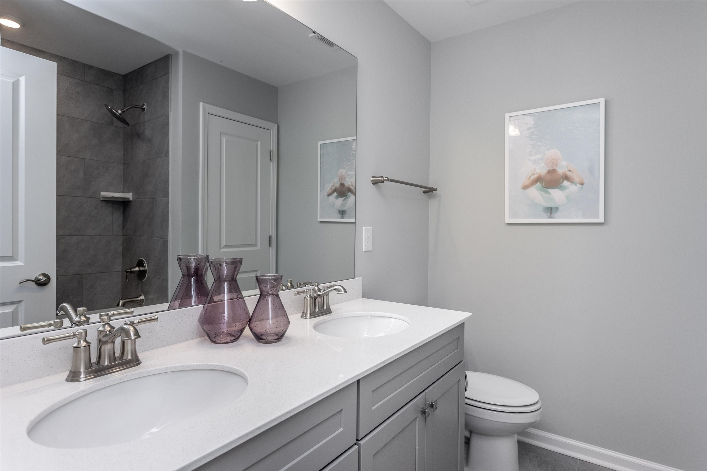 5701 Preveza Place Raleigh, NC 27603 - Photo 19 of 21 a bathroom with a sink a toilet and mirror
