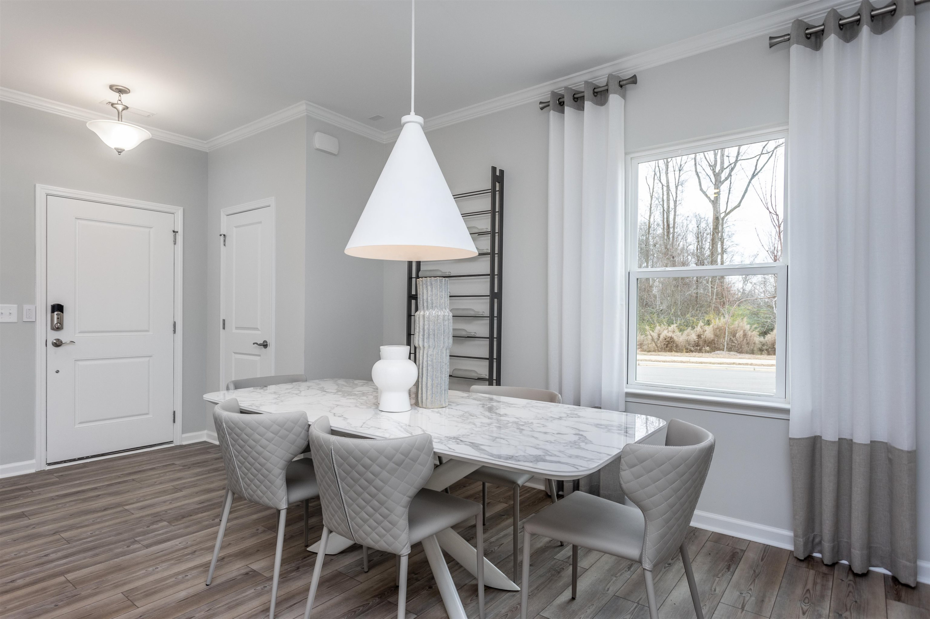 5701 Preveza Place Raleigh, NC 27603 - Photo 3 of 21 a view of a dining room with furniture window and wooden floor