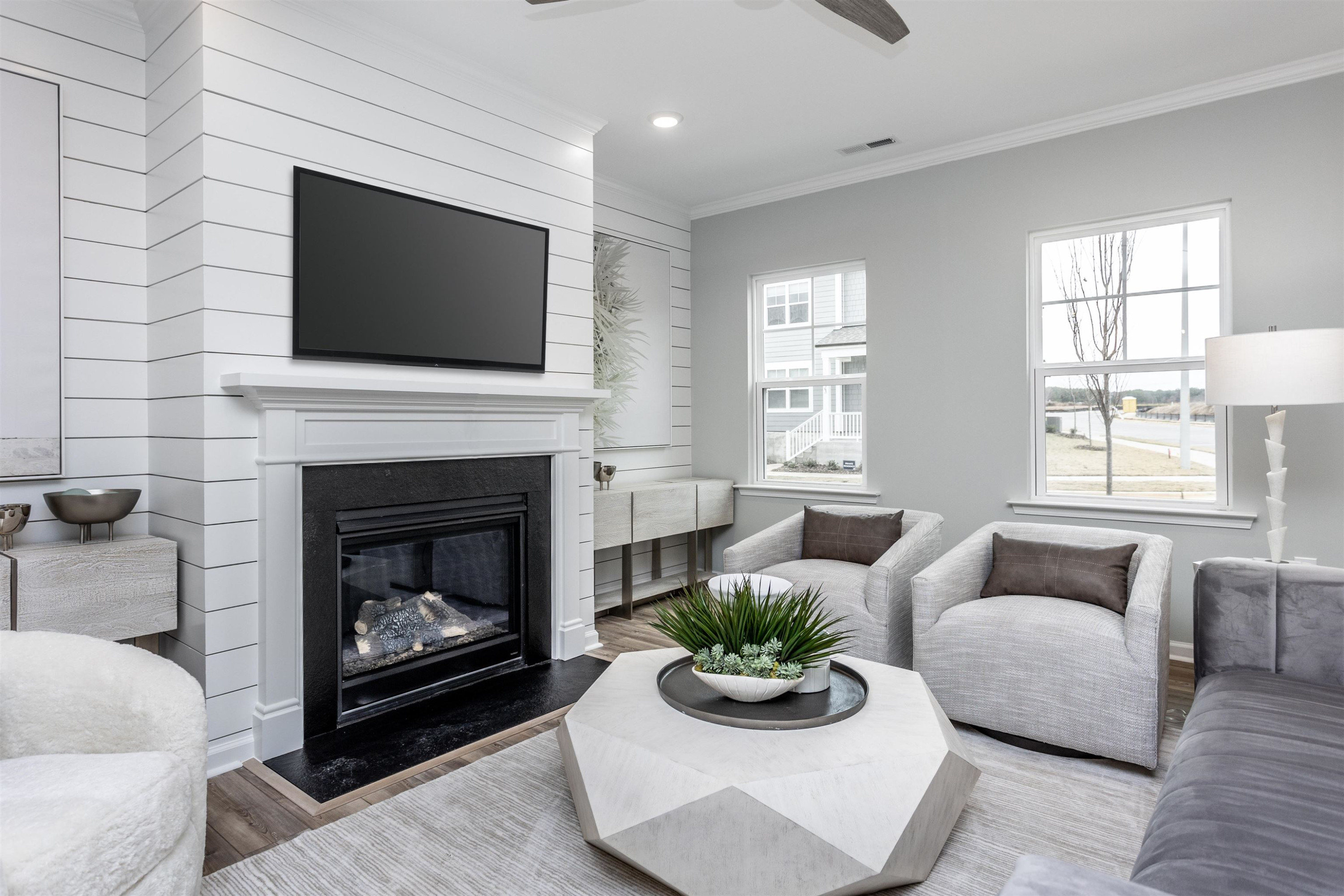 5701 Preveza Place Raleigh, NC 27603 - Photo 5 of 21 a living room with furniture a flat screen tv and a fireplace