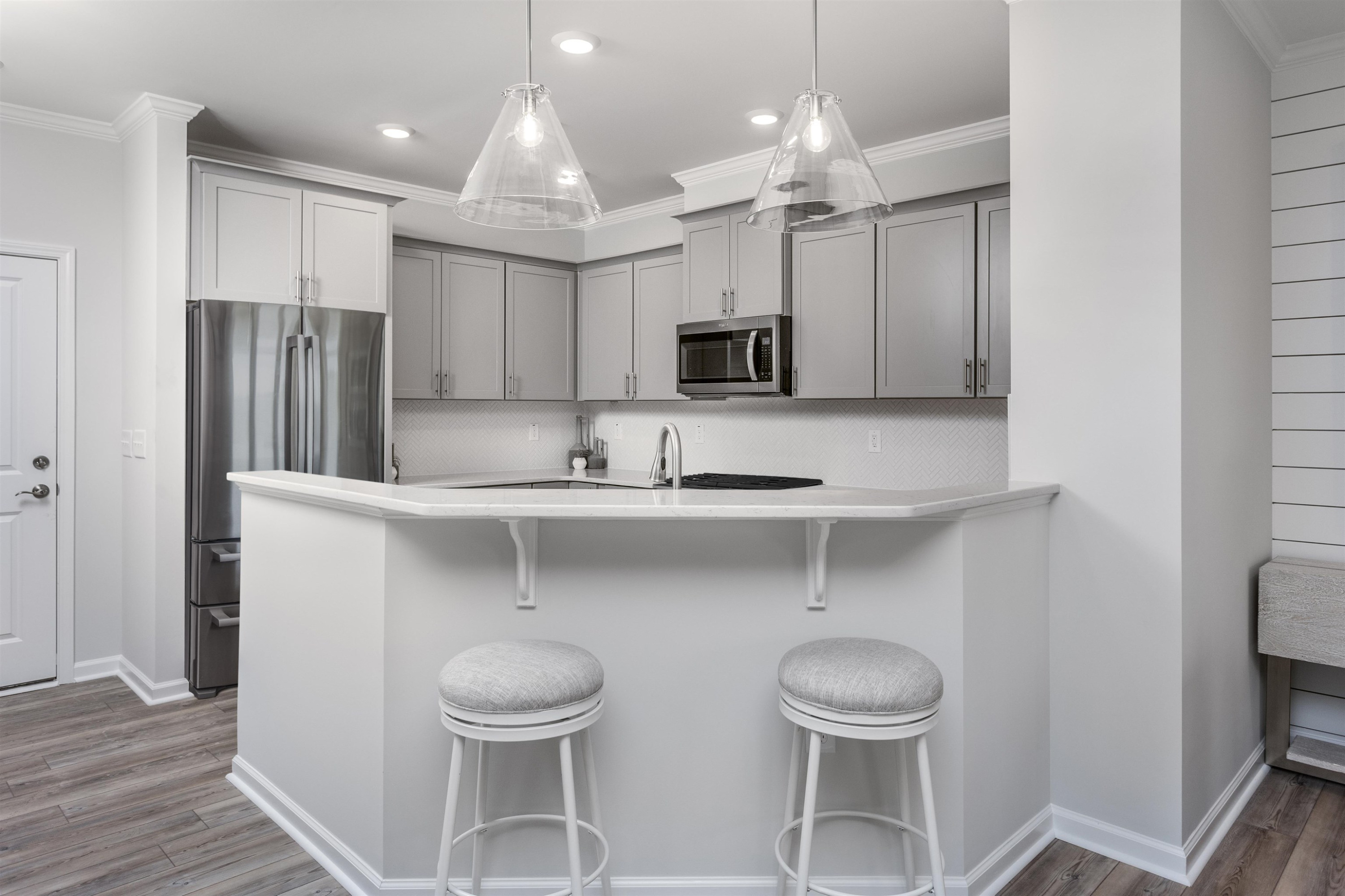 5701 Preveza Place Raleigh, NC 27603 - Photo 8 of 21 a kitchen with stainless steel appliances a table and chairs in it