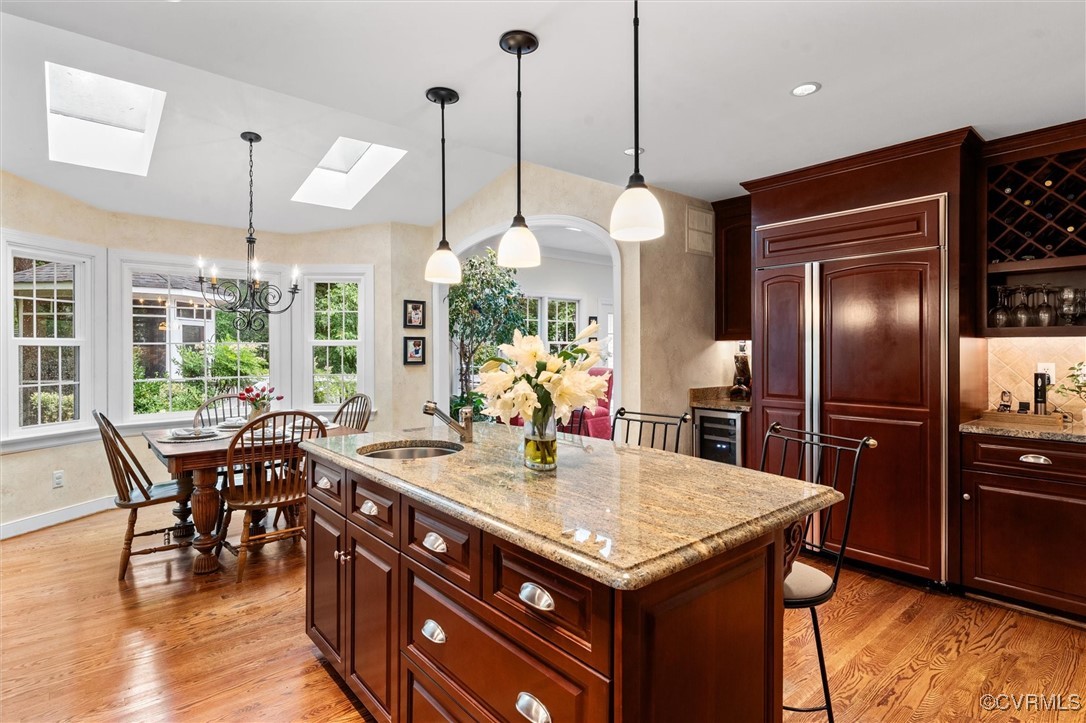 5911 Waters Edge Road Midlothian, VA 23112 - Photo 16 of 50 Kitchen featuring a sink, a skylight, light wood f