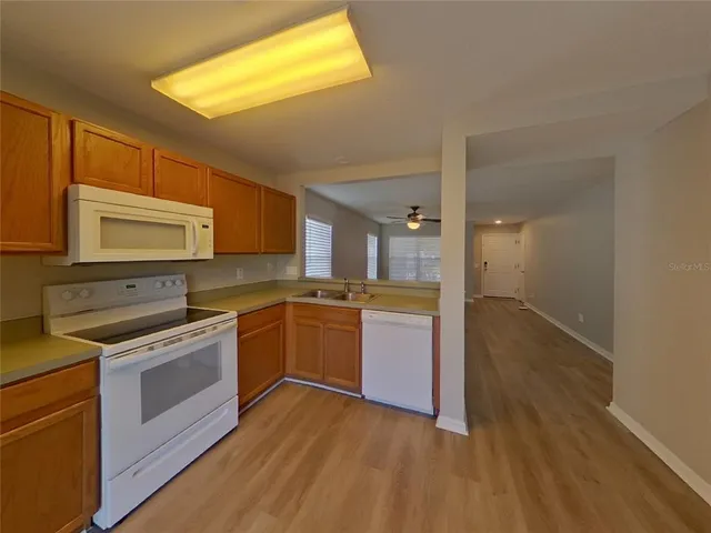 a kitchen with a sink and a stove top oven