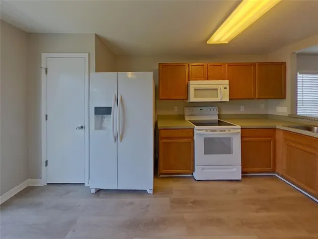a kitchen with stainless steel appliances a stove a sink and a refrigerator