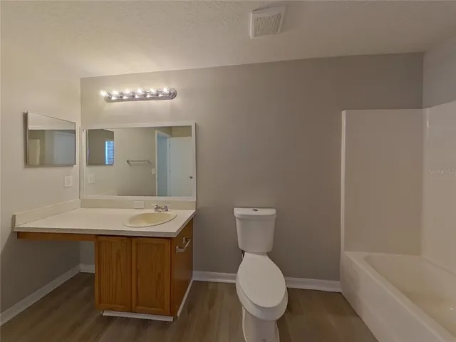 a bathroom with a toilet a sink and bathtub