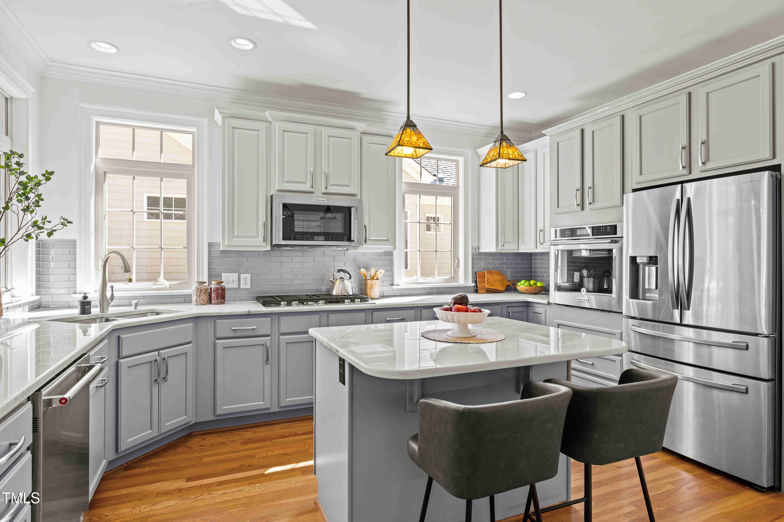 10040 Ward Chapel Hill, NC 27517 - Photo 18 of 56 a kitchen with refrigerator a sink and chairs