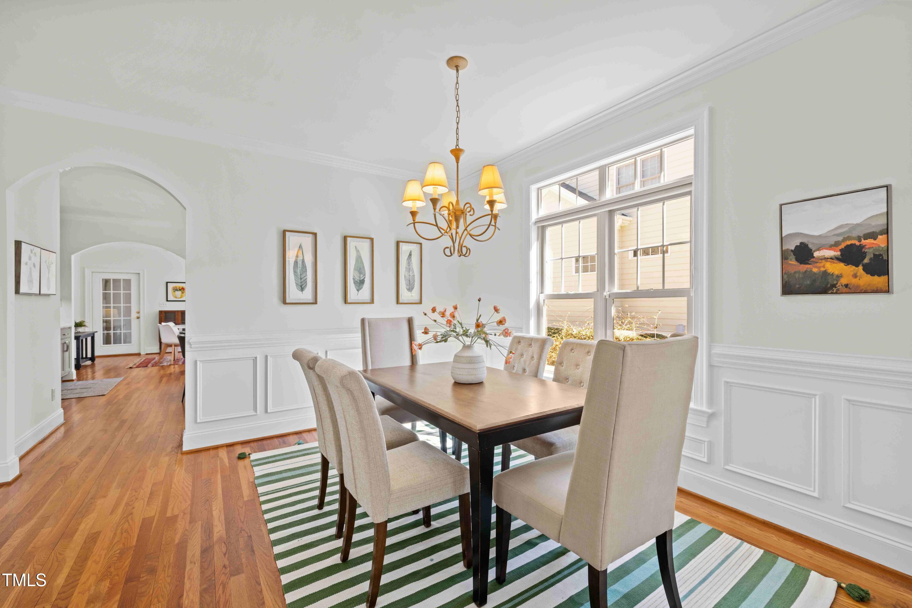 10040 Ward Chapel Hill, NC 27517 - Photo 23 of 56 a dining room with furniture a chandelier and wooden floor