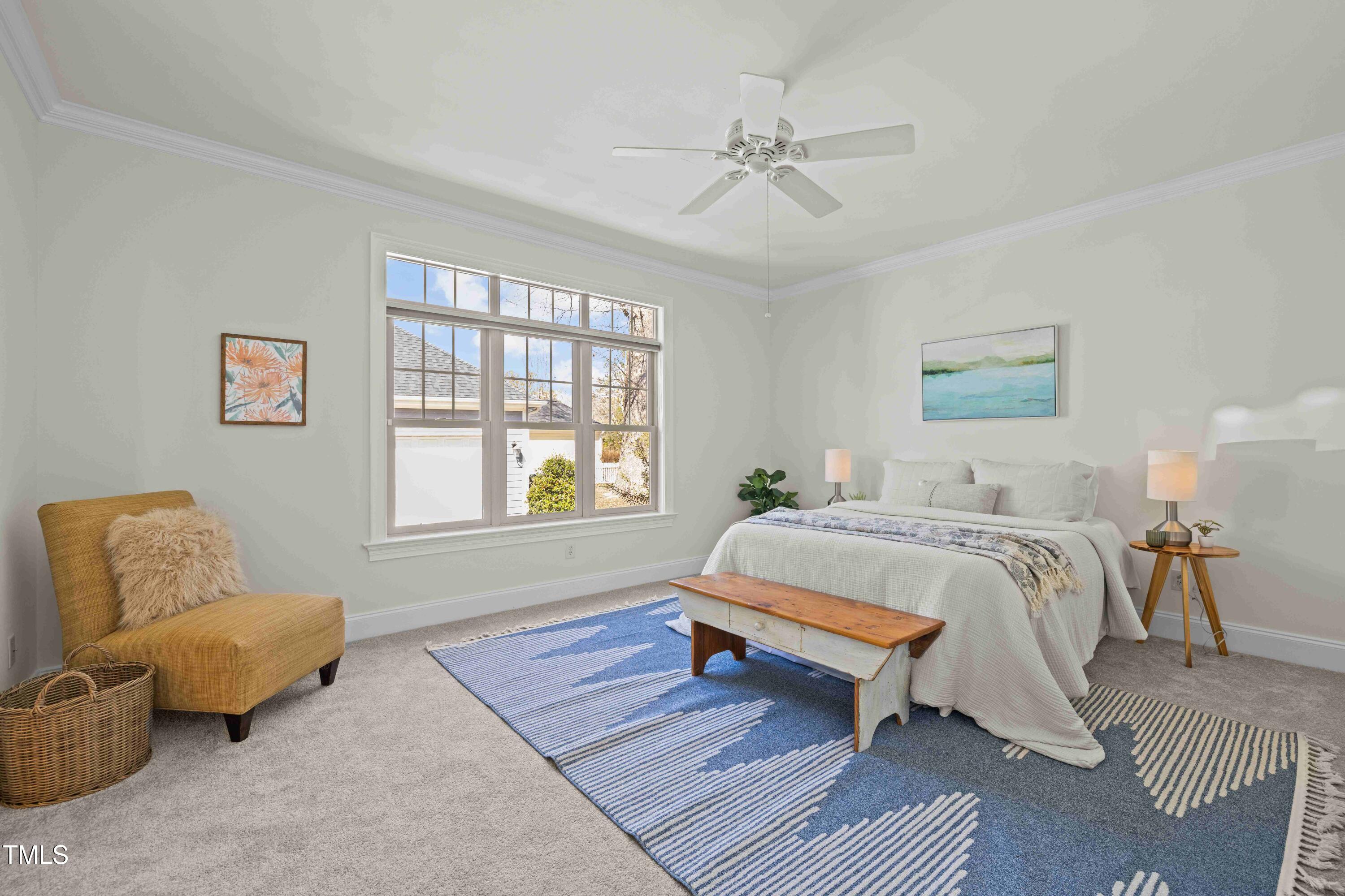 10040 Ward Chapel Hill, NC 27517 - Photo 25 of 56 a spacious bedroom with a bed a couch and a window