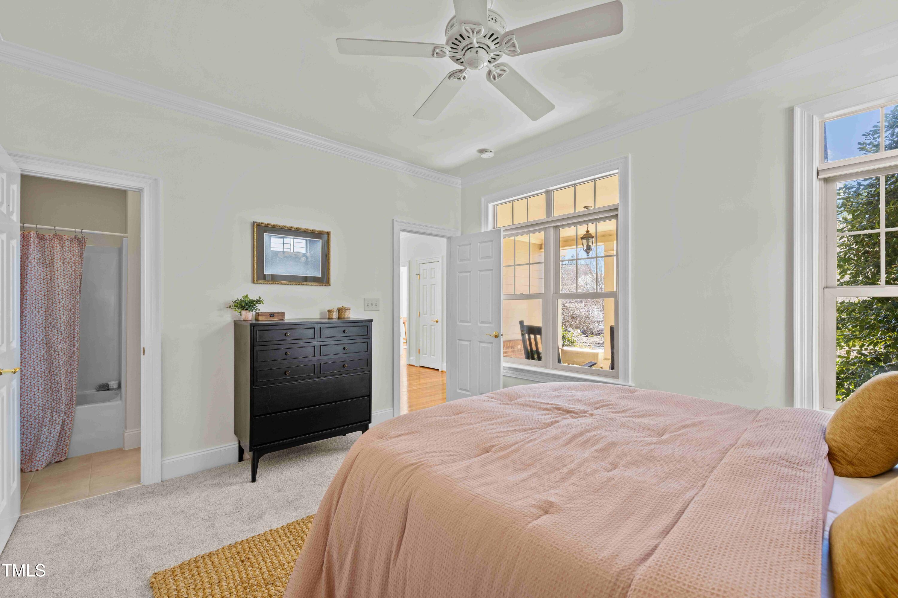 10040 Ward Chapel Hill, NC 27517 - Photo 8 of 56 a bedroom with a bed and a chandelier