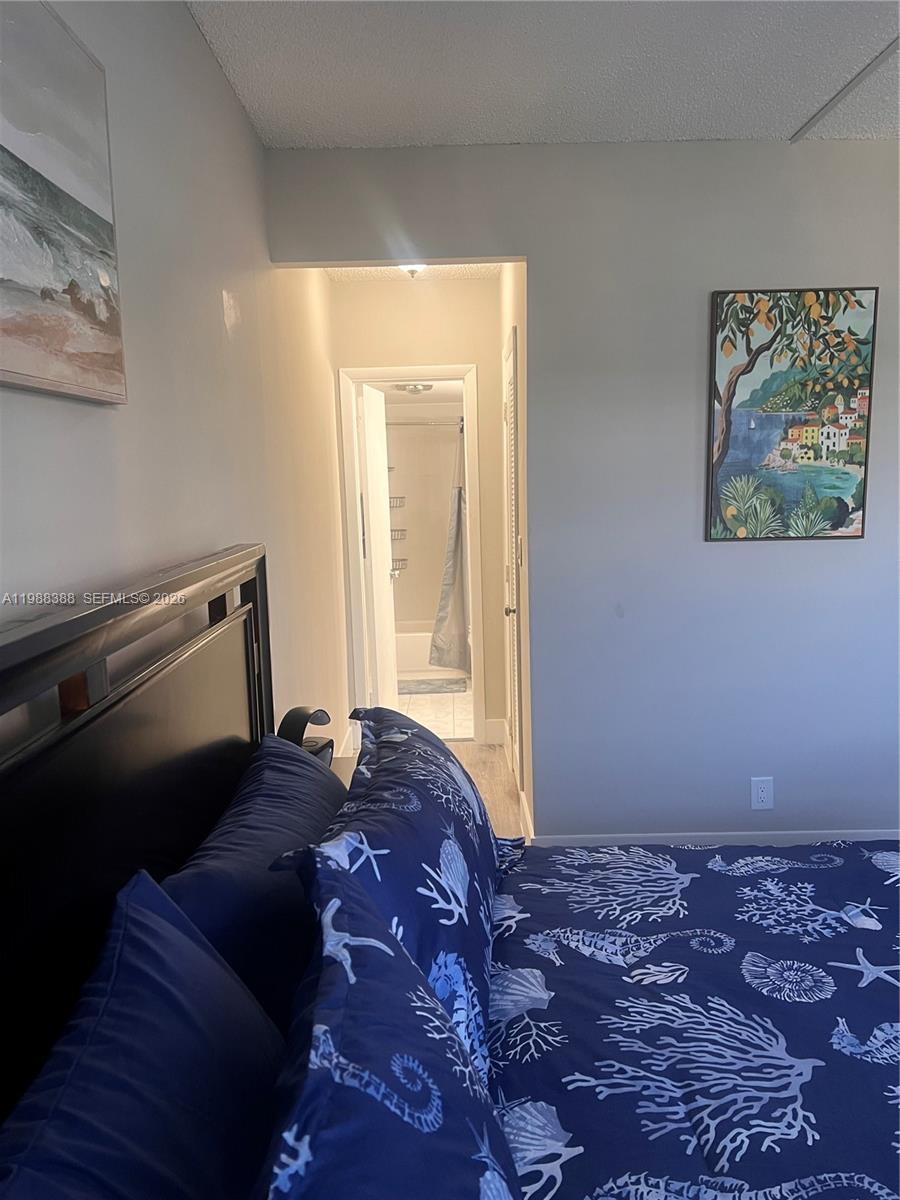 400 North Riverside Drive, Unit 214 Pompano Beach, FL 33062 - Photo 15 of 67 a bed sitting in a bedroom next to a window