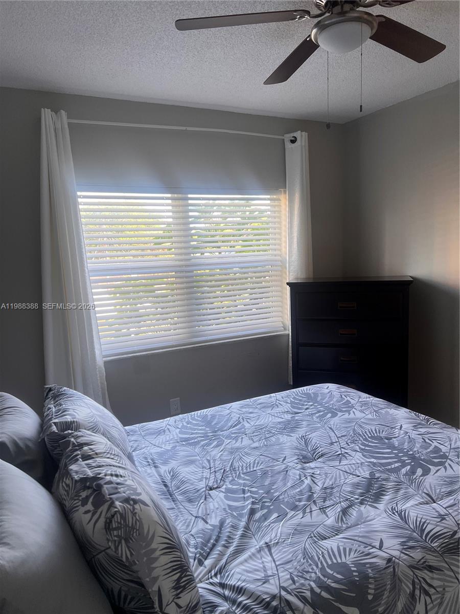400 North Riverside Drive, Unit 214 Pompano Beach, FL 33062 - Photo 19 of 67 a bedroom with a large bed and a window