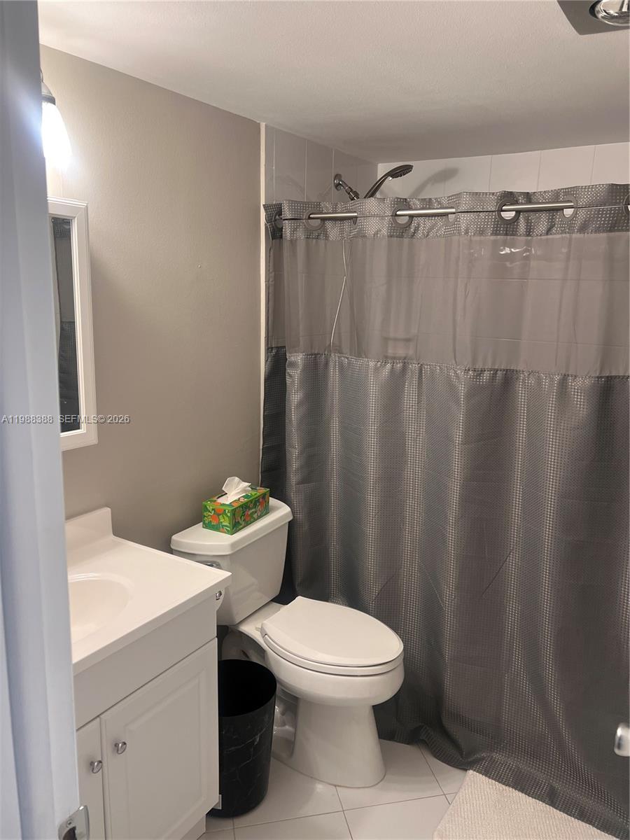 400 North Riverside Drive, Unit 214 Pompano Beach, FL 33062 - Photo 21 of 67 a white toilet sitting next to a bathroom sink