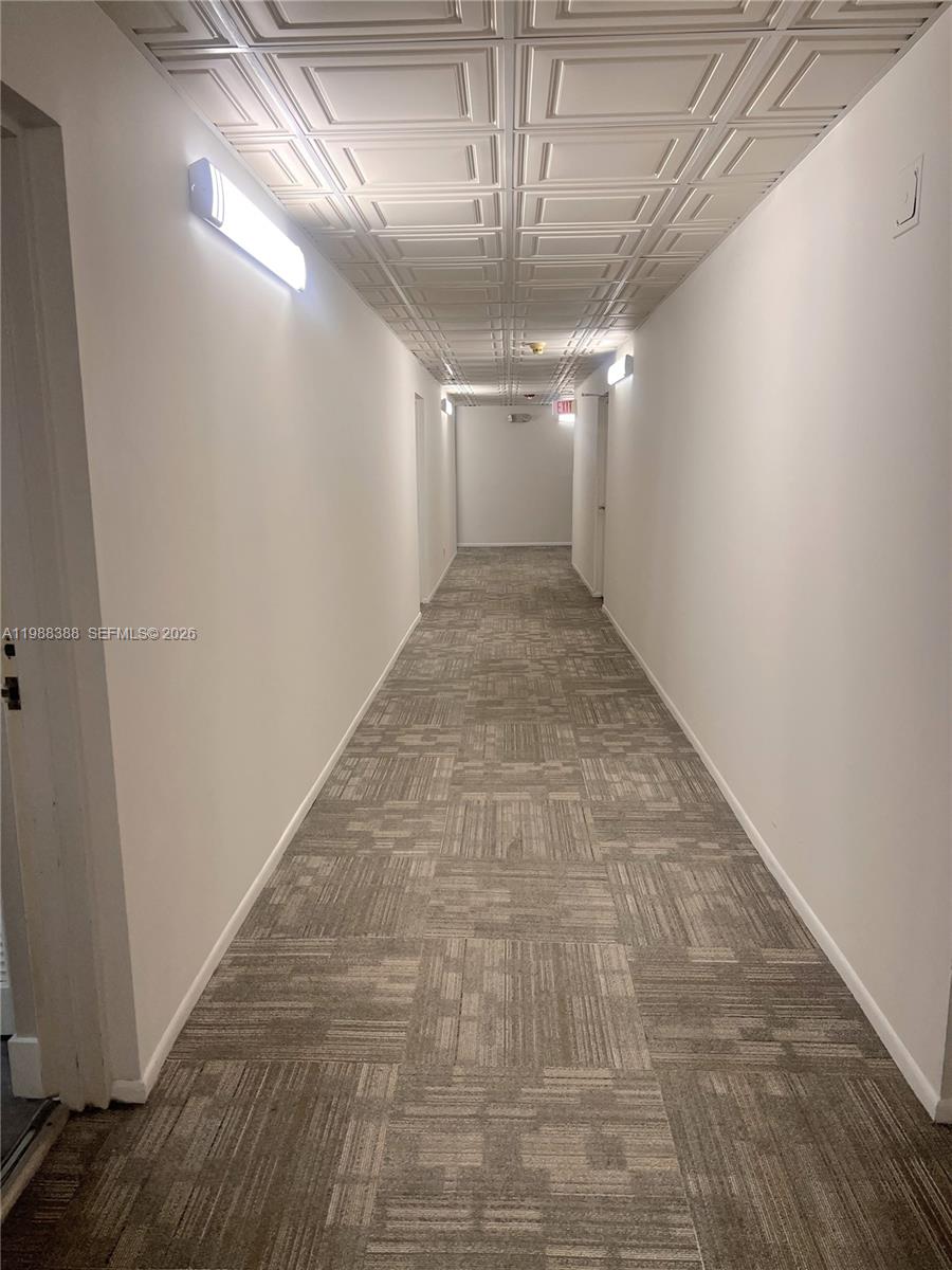 400 North Riverside Drive, Unit 214 Pompano Beach, FL 33062 - Photo 24 of 67 a view of hallway with a ceiling fan