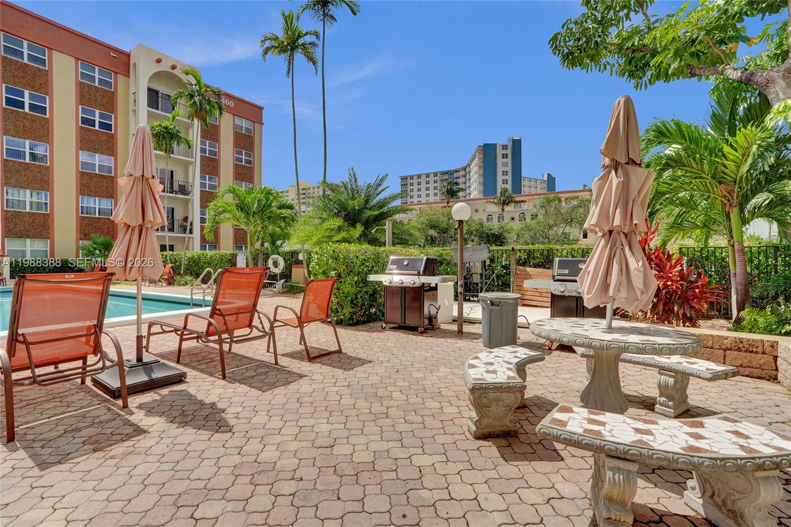 400 North Riverside Drive, Unit 214 Pompano Beach, FL 33062 - Photo 30 of 67 a view of a patio with dining table and chairs potted plants