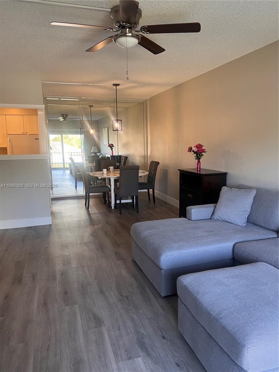 400 North Riverside Drive, Unit 214 Pompano Beach, FL 33062 - Photo 5 of 67 a living room with furniture and a chandelier