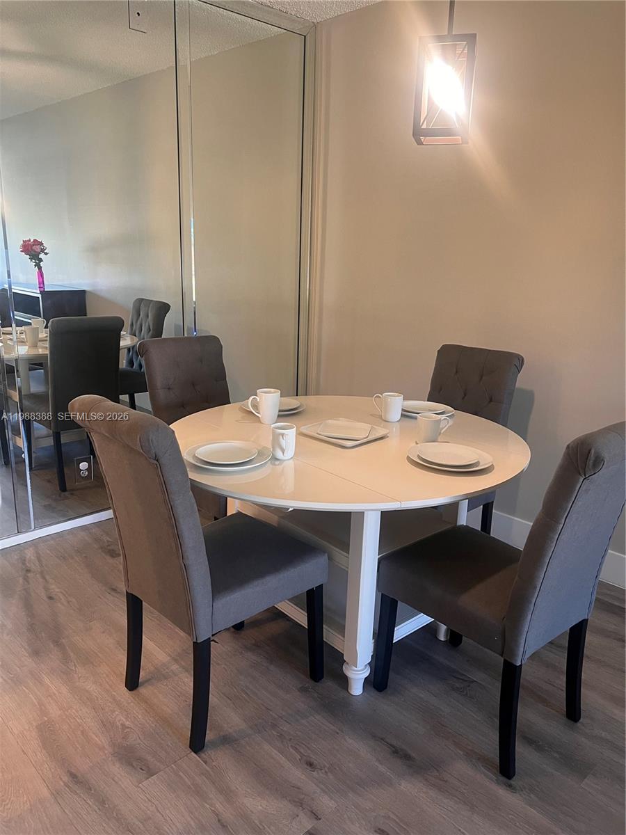 400 North Riverside Drive, Unit 214 Pompano Beach, FL 33062 - Photo 6 of 67 a view of a dining room with furniture and wooden floor