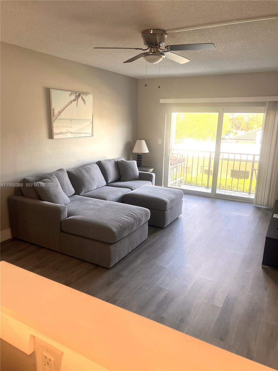 400 North Riverside Drive, Unit 214 Pompano Beach, FL 33062 - Photo 7 of 67 a living room with furniture and a large window