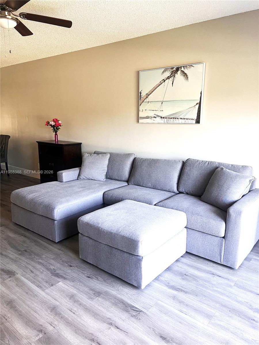 400 North Riverside Drive, Unit 214 Pompano Beach, FL 33062 - Photo 8 of 67 a living room with furniture and a wooden floor