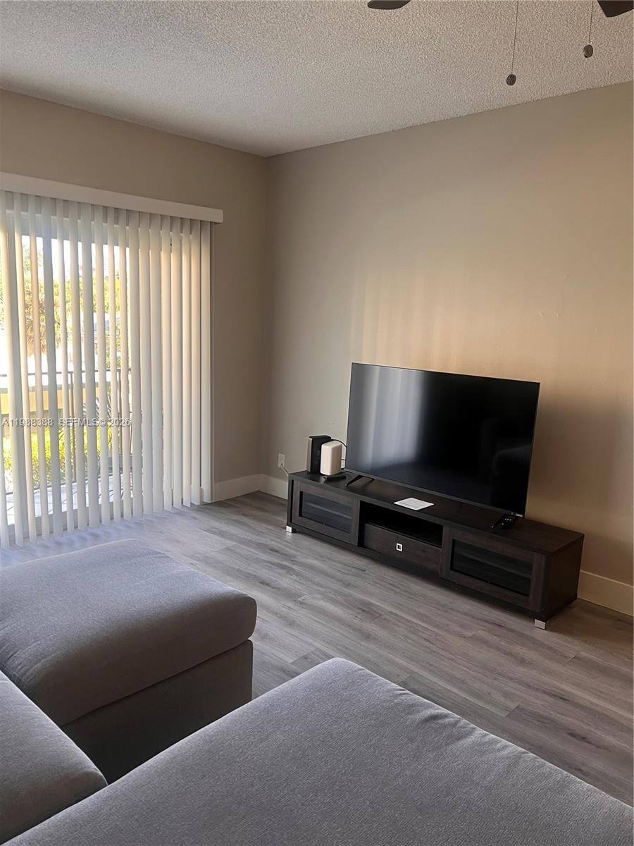 400 North Riverside Drive, Unit 214 Pompano Beach, FL 33062 - Photo 9 of 67 a living room with furniture and a flat screen tv