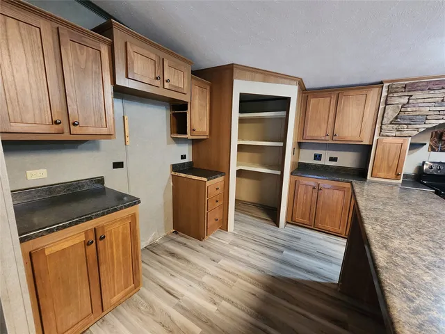 a kitchen with wooden cabinets and a stove top oven