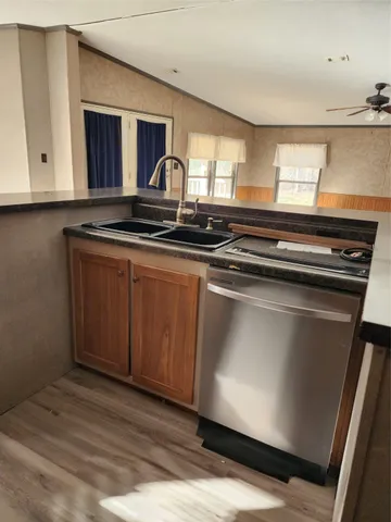 a view of kitchen with sink microwave and refrigerator