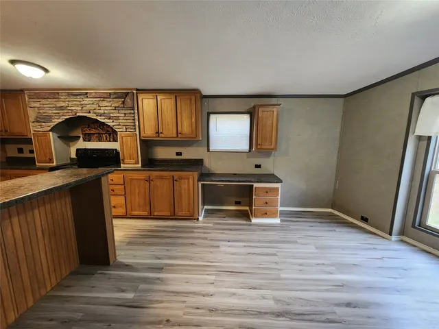 a view of kitchen with sink microwave and refrigerator