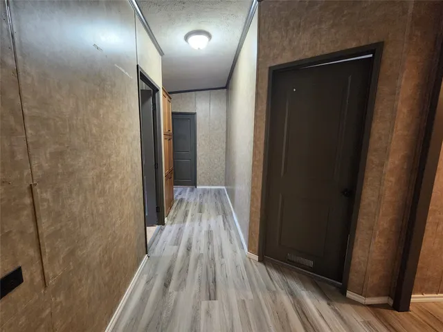 a view of hallway with wooden floor