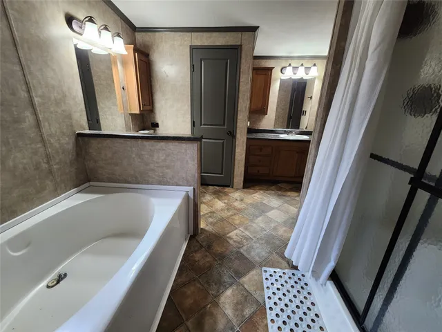 a bathroom with a bathtub and a shower