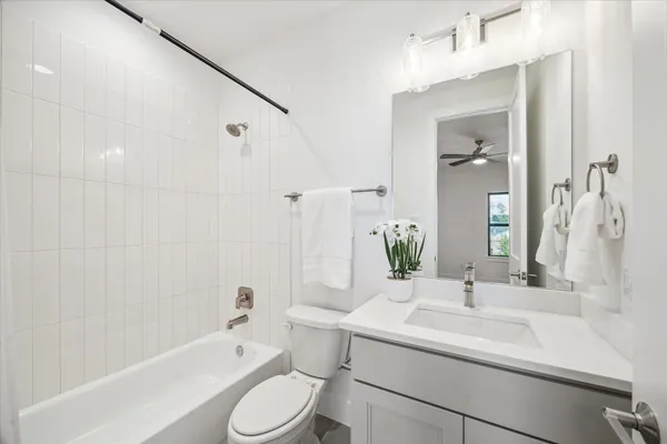 a bathroom with a sink toilet tub and shower