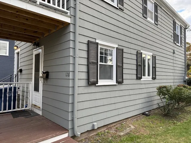 a view of a house with a door and wooden walls
