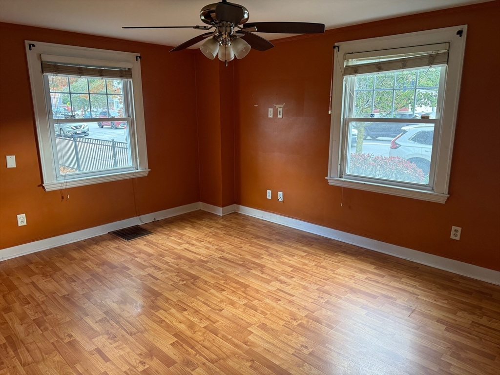 128 Boston Street, Unit 4 Salem, MA 01970 - Photo 3 of 17 a view of an empty room with wooden floor and a window