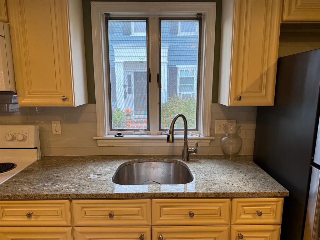 128 Boston Street, Unit 4 Salem, MA 01970 - Photo 4 of 17 a kitchen with sink and window