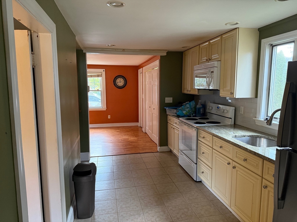 128 Boston Street, Unit 4 Salem, MA 01970 - Photo 6 of 17 a large kitchen with a sink and a large window