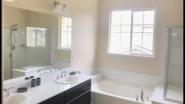 a bathroom with a bathtub sink and mirror