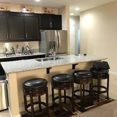 a kitchen with a table chairs sink and cabinets
