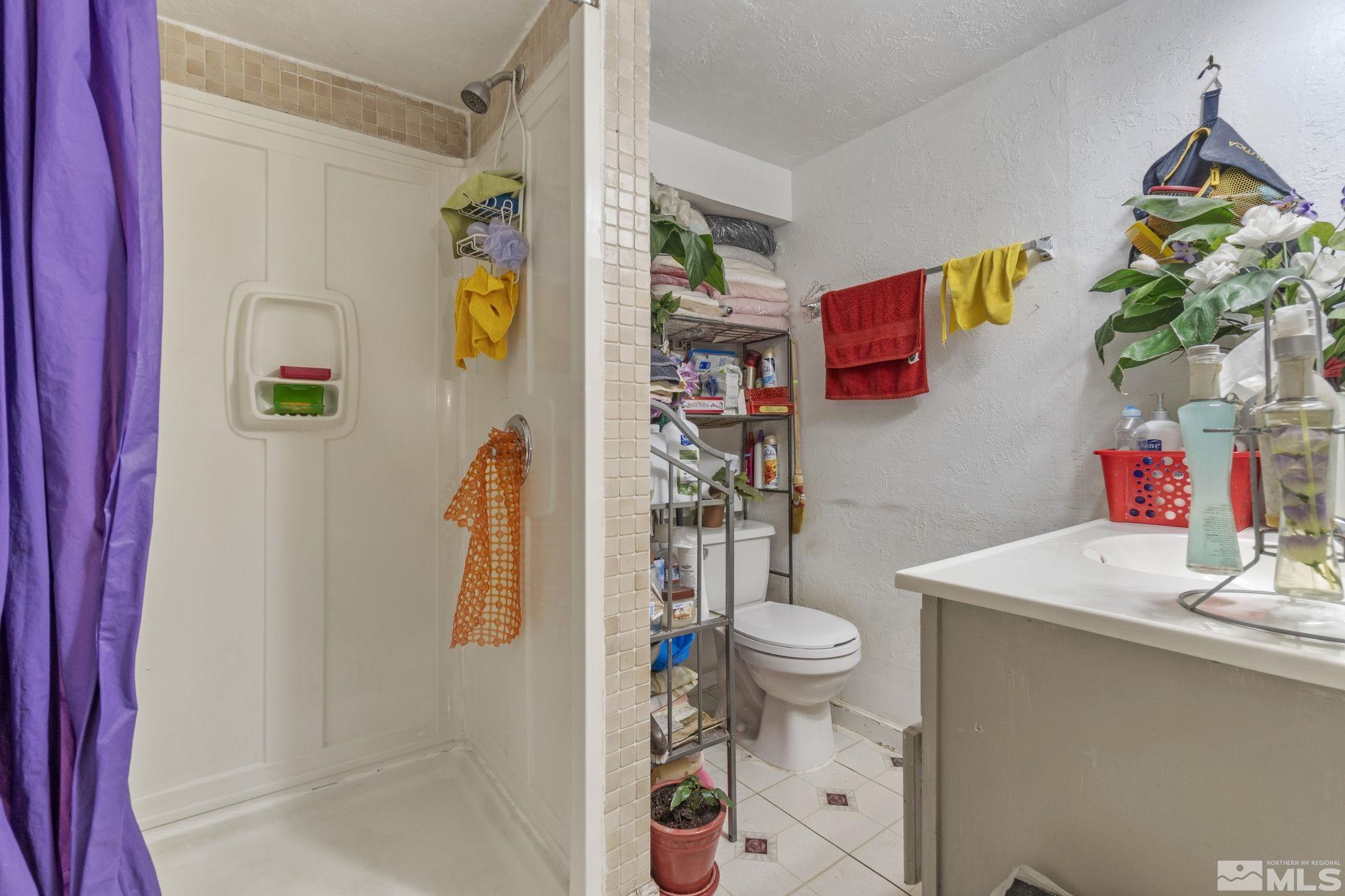 1905 Citron Street Reno, NV 89512 - Photo 12 of 18 a bathroom with a sink mirror vanity and toilet