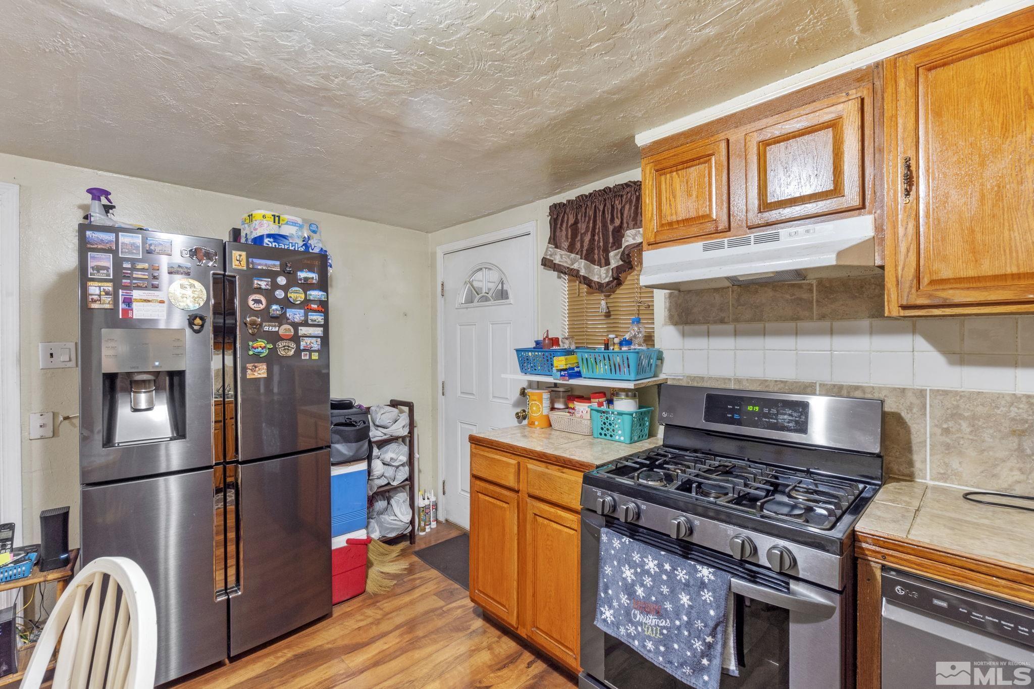 1905 Citron Street Reno, NV 89512 - Photo 5 of 18 a kitchen with stainless steel appliances granite countertop a stove a refrigerator and a refrigerator