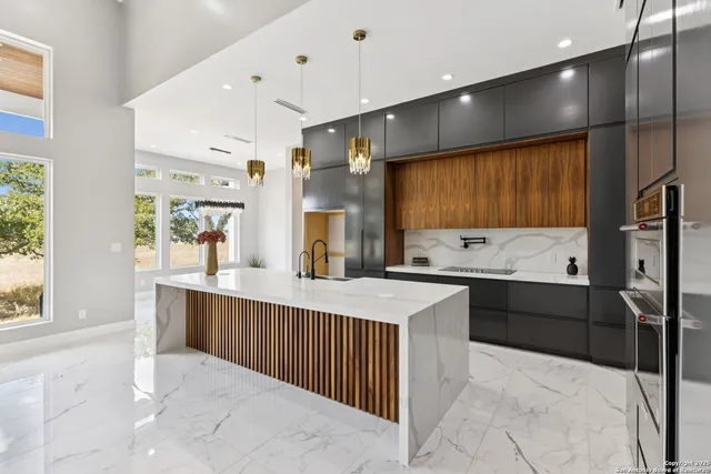 a bathroom with a sink a large mirror and a shower