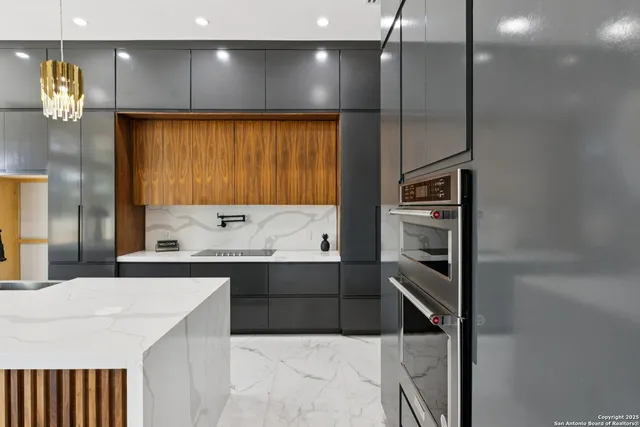 a kitchen with granite countertop stainless steel appliances a sink and cabinets